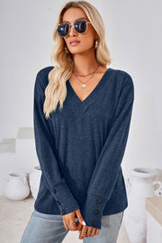 Button-cuff slouch v-neck top in Dusty Blue with button details on the sleeves.