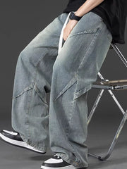 Men's oversized blue denim jeans with adjustable fit and unique paneling detail.