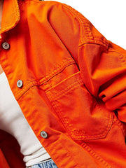Orange denim trucker jacket with button closure and chest pockets.