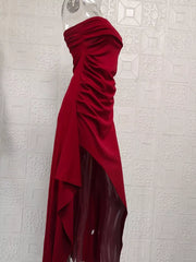 Burgundy ruched strapless maxi dress with a high slit and flowing skirt.
