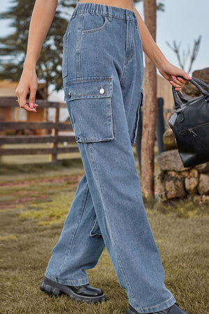 Relaxed wide leg denim cargo pants in light wash with utility pockets and button details.