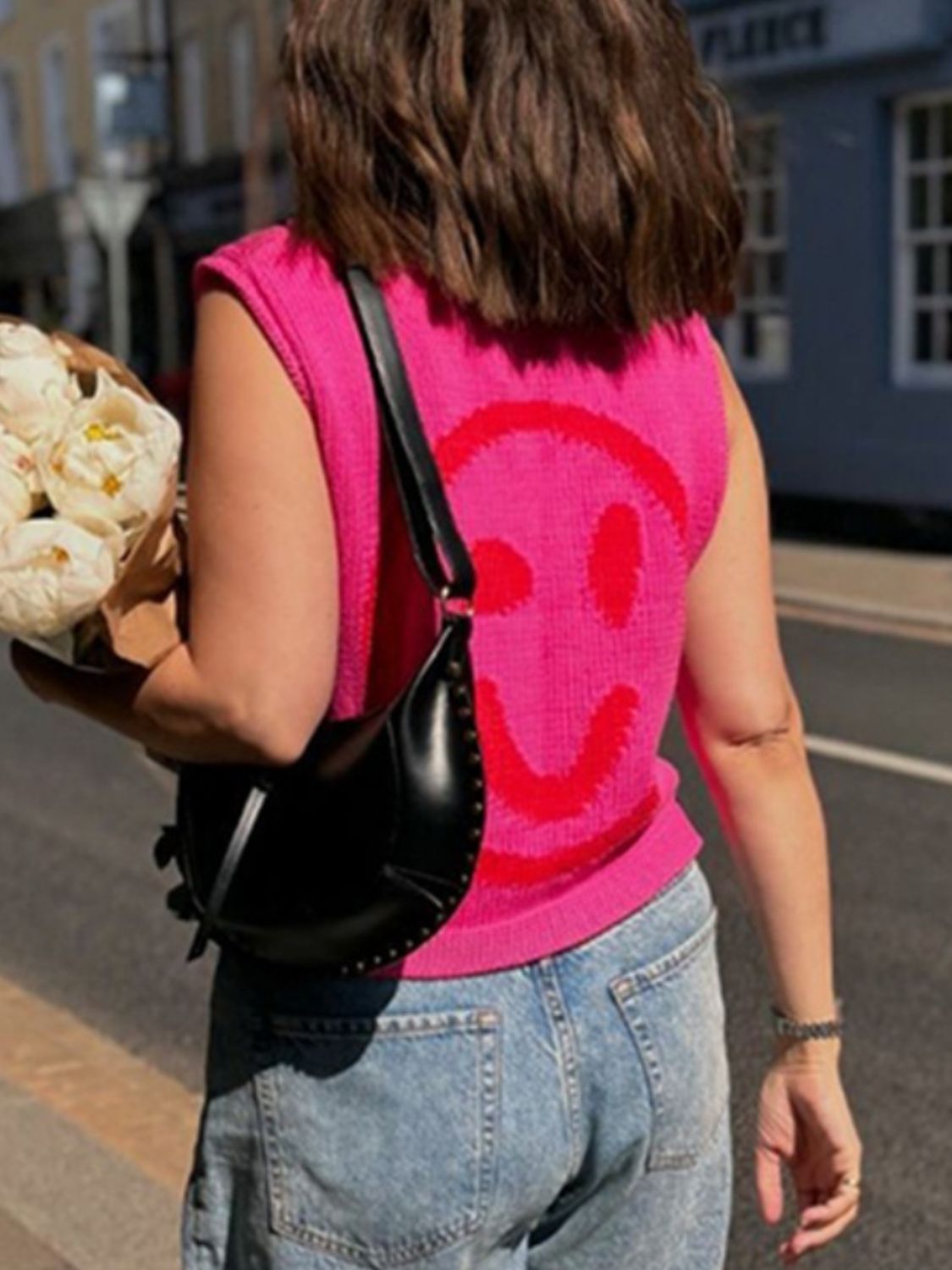 Pink knit tank top with red smiley face graphic.