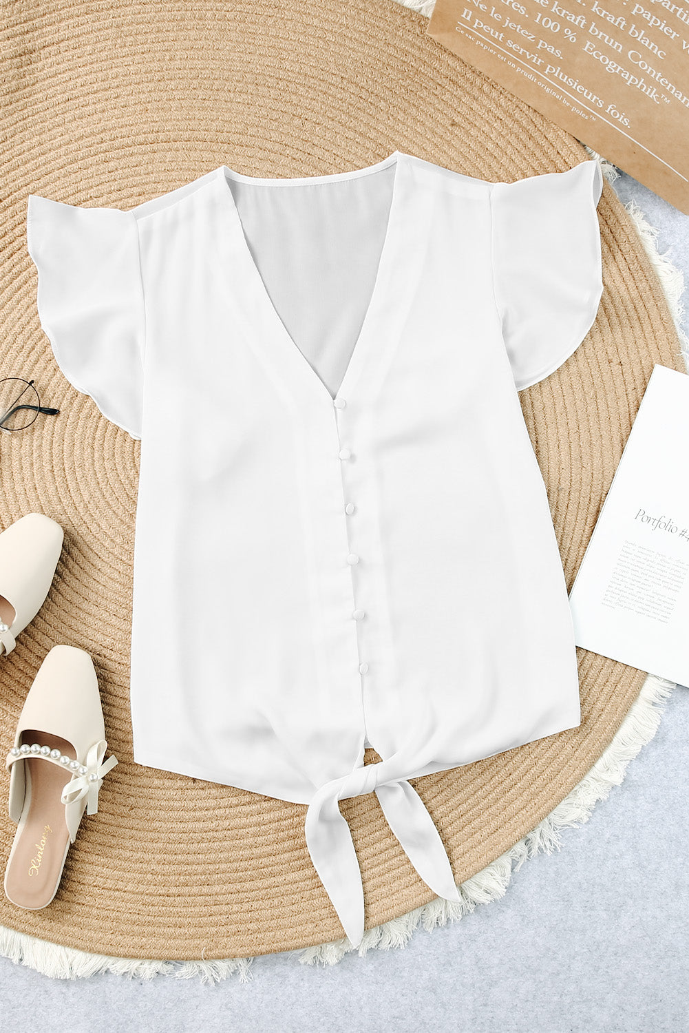 White button-down blouse with ruffle sleeves and a tie-front detail