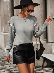 Light gray crew neck sweater with contrast trim ruffle shoulders and long sleeves.