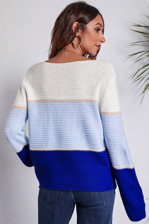 Colorblock ribbed boatneck sweater in white, light blue, and royal blue with beige accents.