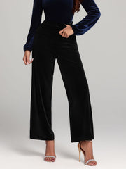 Black velvet palazzo trousers with a wide leg cut.