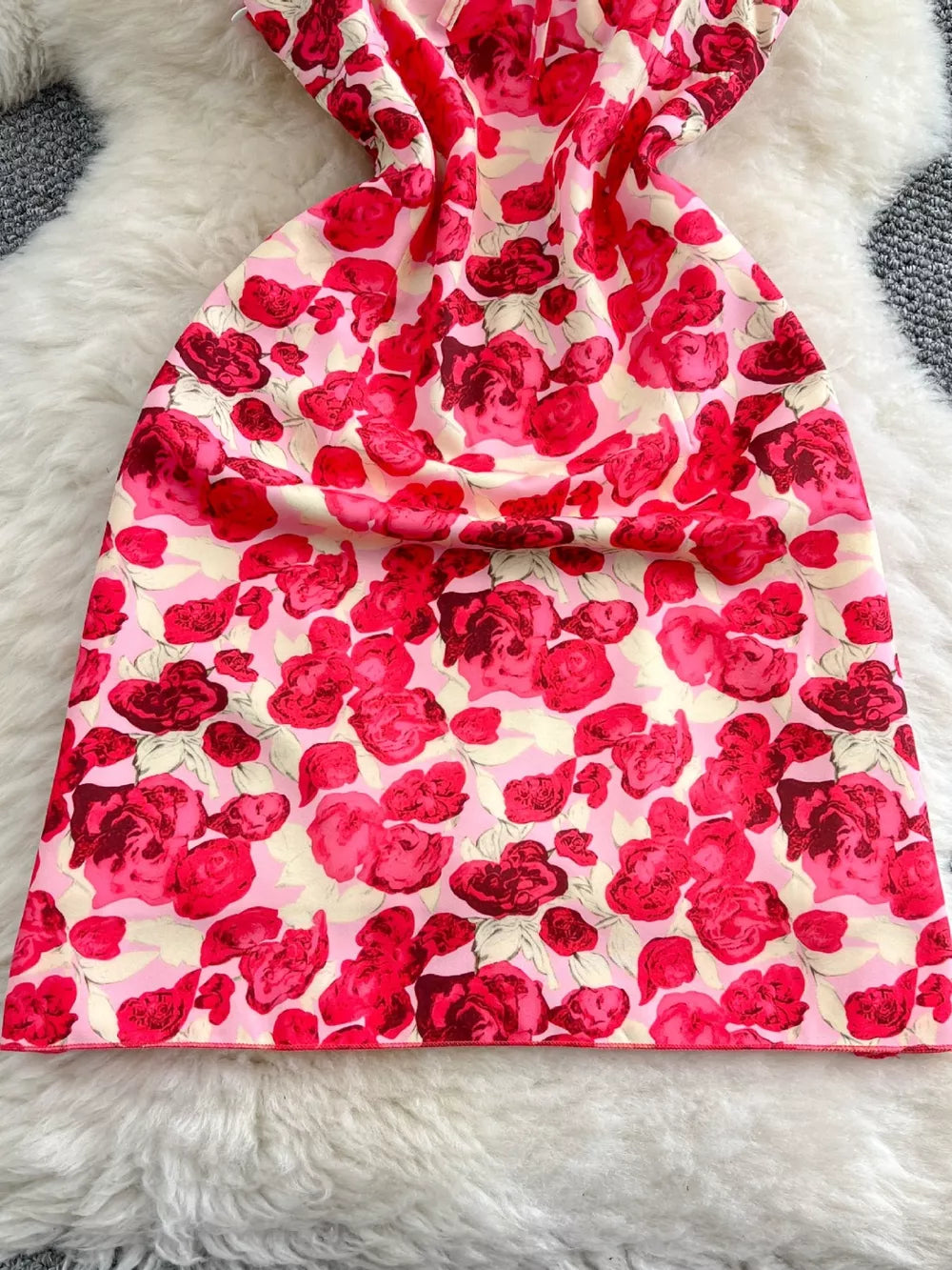 Charming floral ruffle trim mini dress with a pink and red rose print