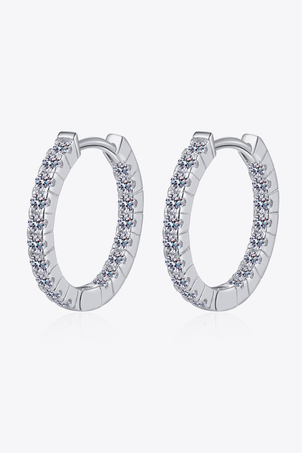 Silver pavé crystal huggie hoop earrings with a polished finish.