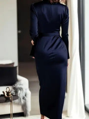 Luxurious satin tie-waist maternity dress in dark blue with long sleeves.