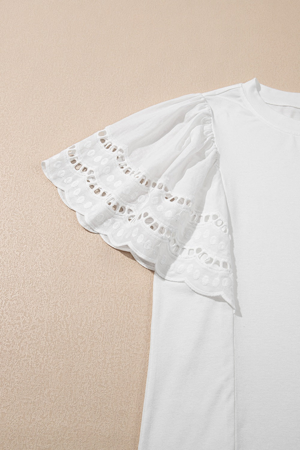 White cotton tee with ruffled lace inset short sleeves and eyelet detail.