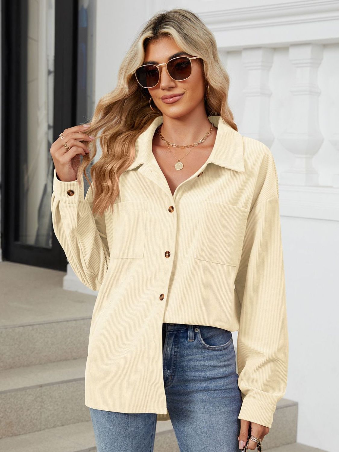 Cream corduroy overshirt with button front and chest pockets.