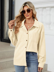 Cream corduroy overshirt with button front and chest pockets.