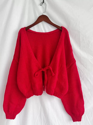Scarlet tie-front knit cardigan with textured fabric and balloon sleeves.