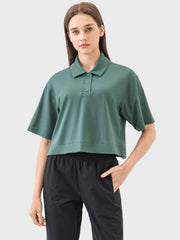 Cropped polo sportif top in green with short sleeves and button placket.