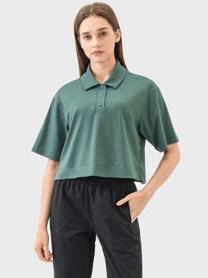 Cropped polo sportif top in green with short sleeves and button placket.