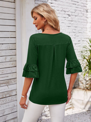 Dark green blouse with ruffled sleeves and a square neckline.