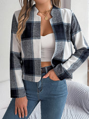 Collarless plaid cropped jacket in dark blue and white with a rounded hem.