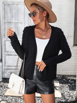 Black acrylic knit cardigan with textured sleeves and open front.