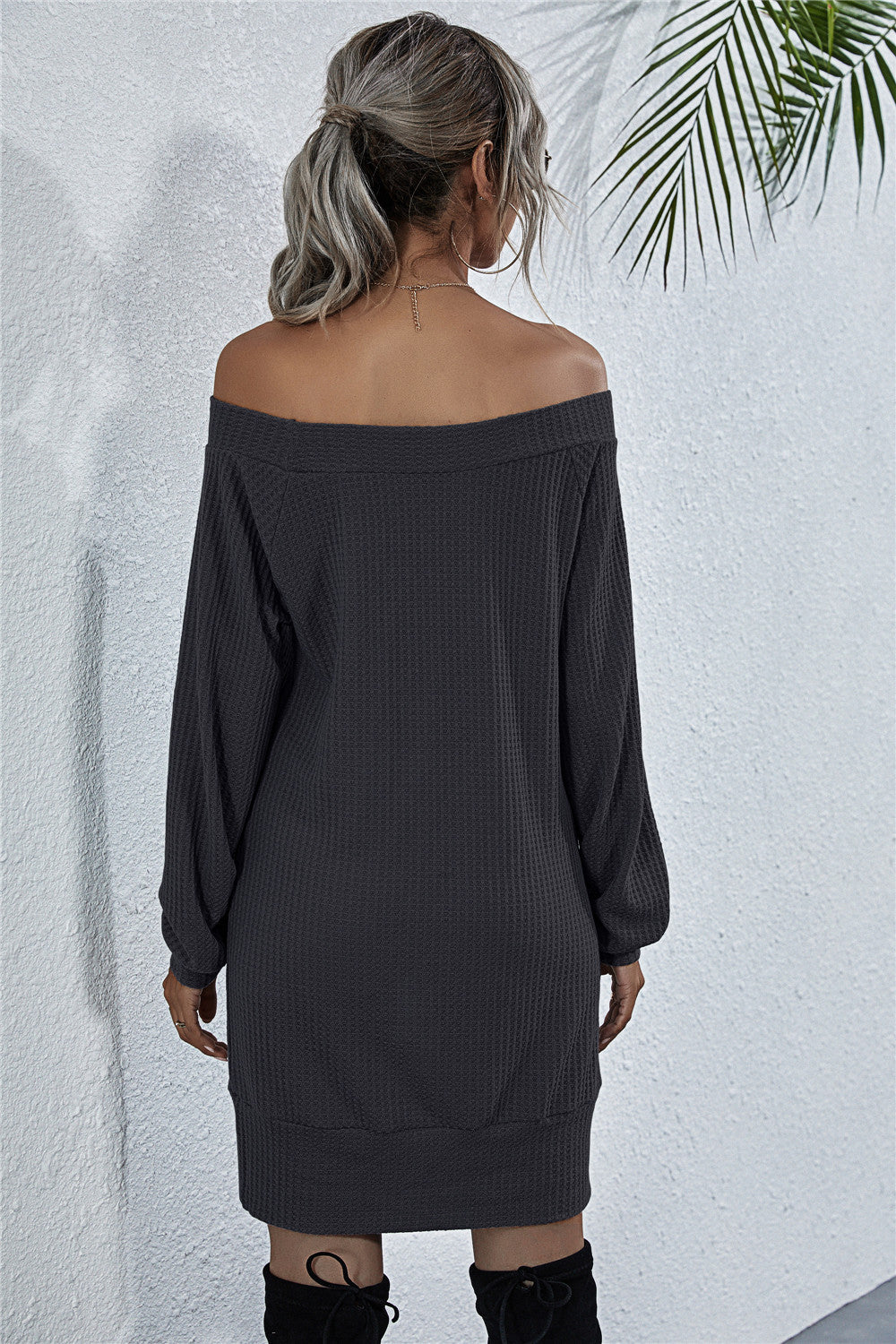 Off-shoulder waffle knit mini dress in dark gray with long sleeves and a relaxed fit.