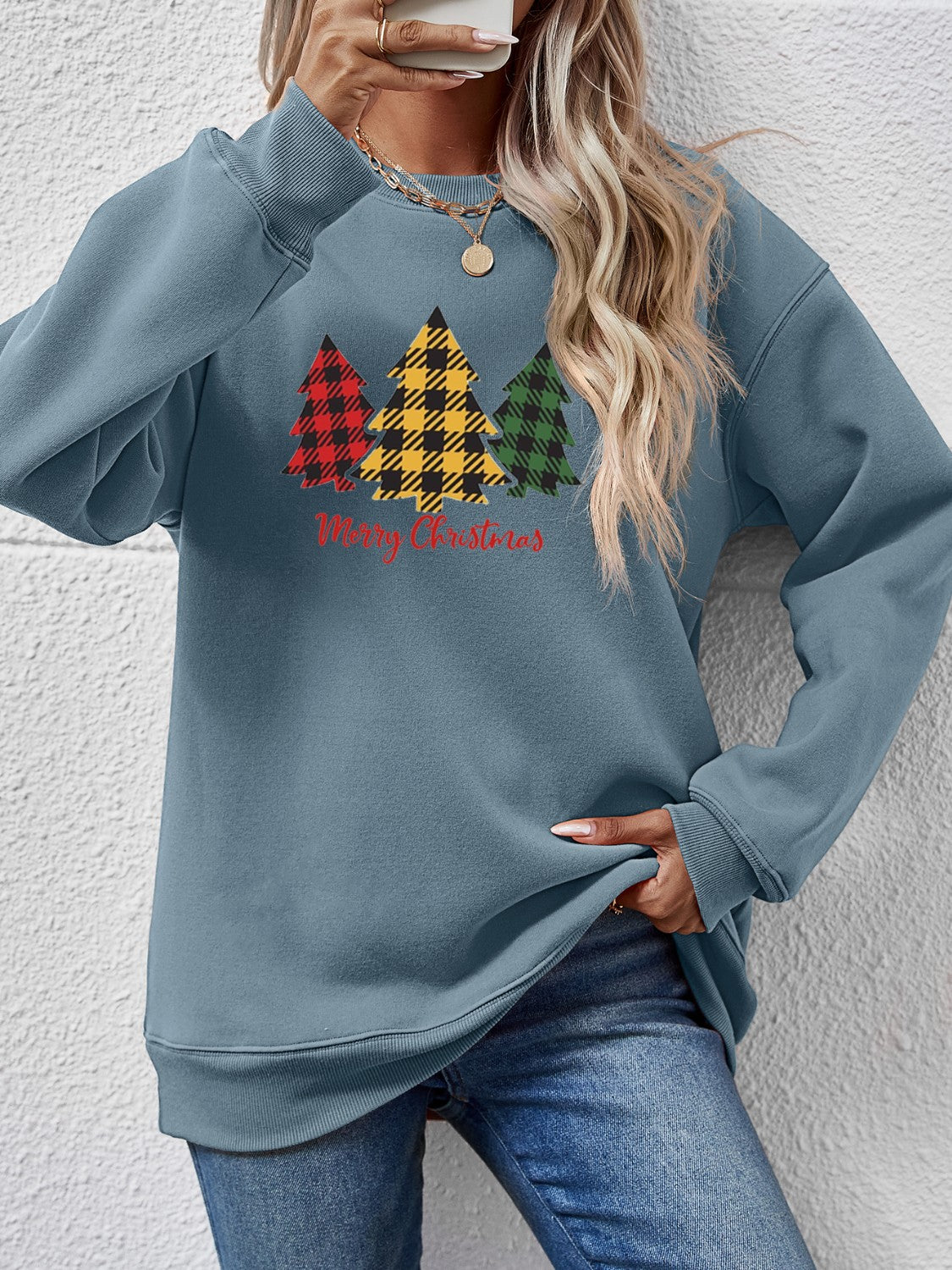 Misty Blue crewneck sweatshirt with plaid Christmas trees graphic and Merry Christmas text.