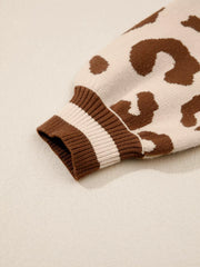 Chic leopard print knit sweater with striped ribbed cuffs.