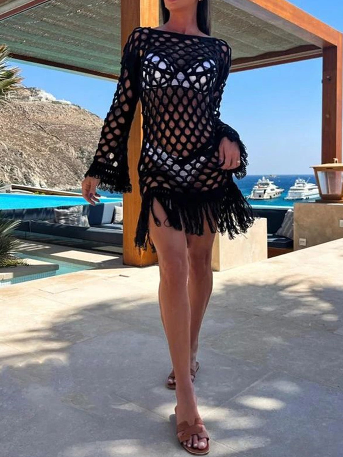 Black open-knit cover-up with fringe sleeves and hem, boat neck, and bell sleeves.