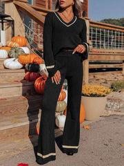 Black knit flare set with contrast trim V-neck top and wide-leg pants.