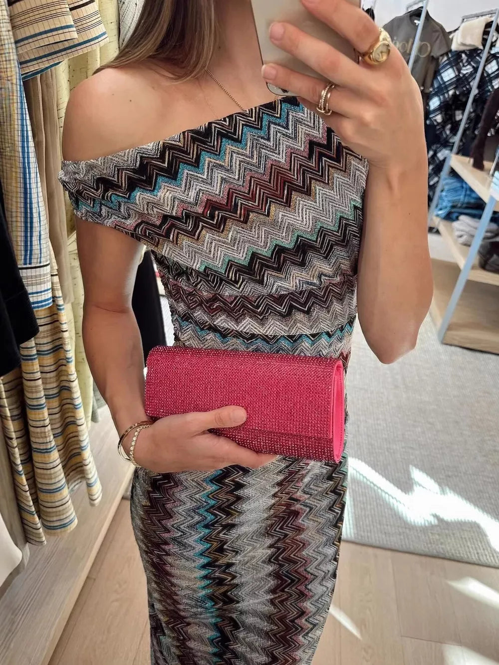 Vibrant one-shoulder maxi dress with chevron pattern and asymmetrical neckline.