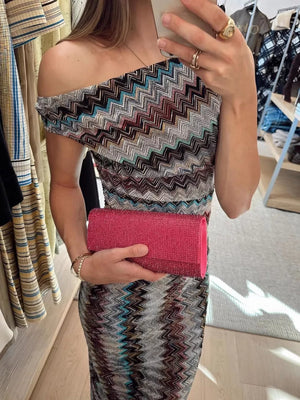 Vibrant one-shoulder maxi dress with chevron pattern and asymmetrical neckline.