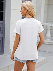 White button-down henley shirt with rolled cuff sleeves and a relaxed fit.