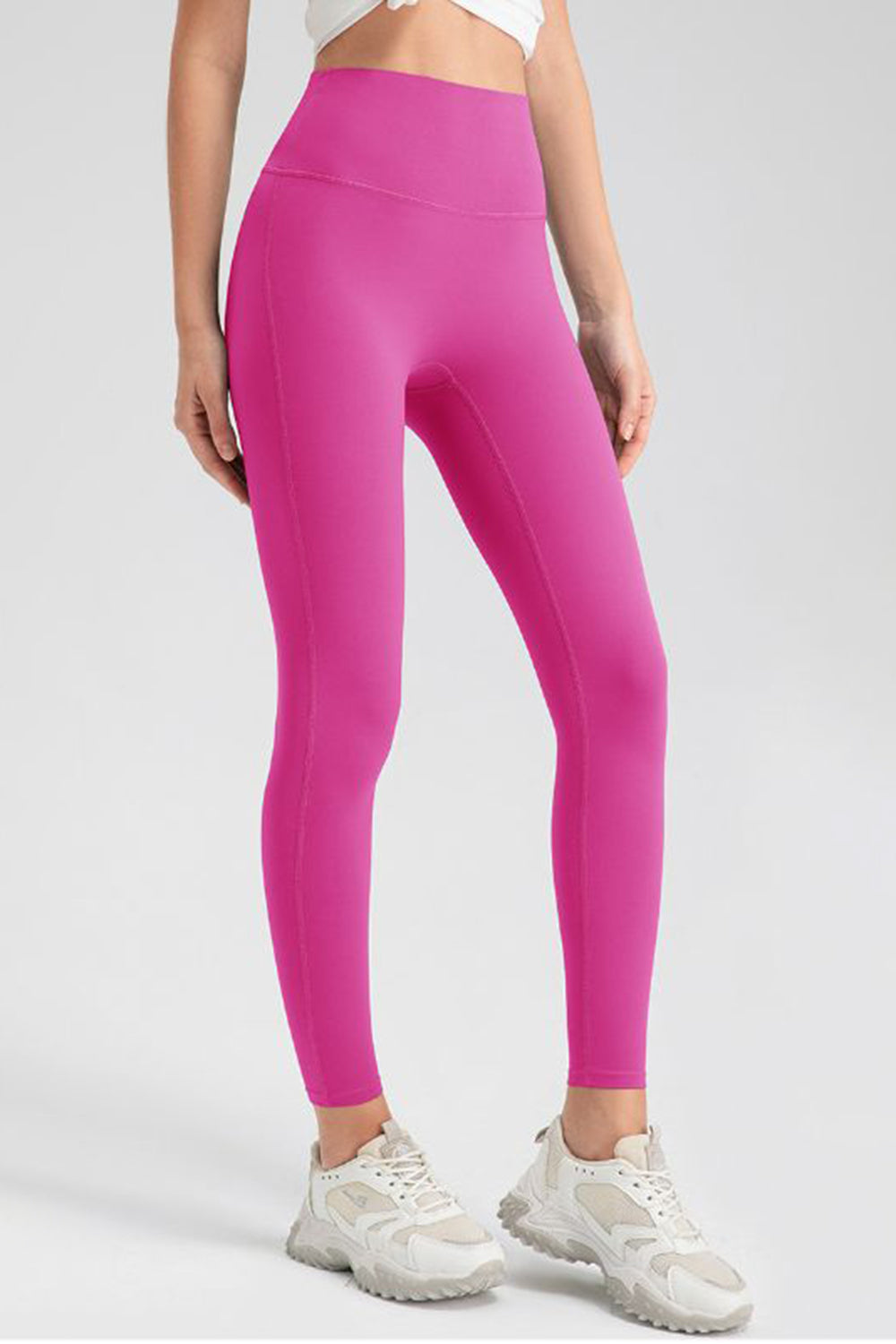Pink high-waist performance leggings with sculpting seams and a full-length cut.
