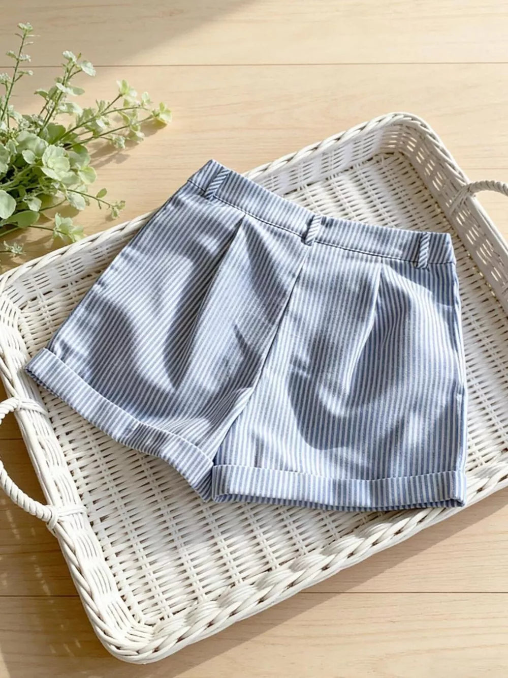 Blue and white striped chino shorts with cuffed hems.