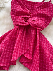Rose red asymmetrical cami top with a twisted knot detail and gingham pattern.
