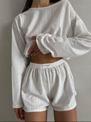 White perforated crop top and shorts set with long sleeves and elastic waist shorts.
