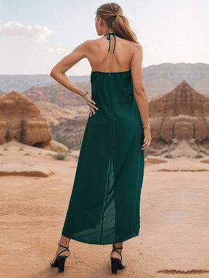 Dark green draped halter jumpsuit with palazzo legs and a back zipper detail.