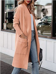 Coral open-front duster cardigan with pockets and relaxed fit, worn with jeans.