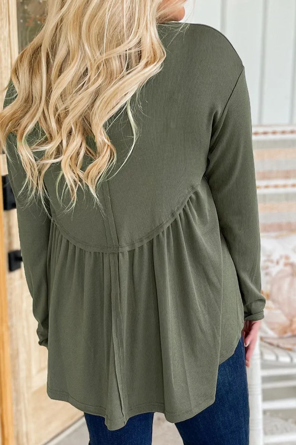 Moss ribbed peplum yoke blouse with long sleeves and a gathered hem.