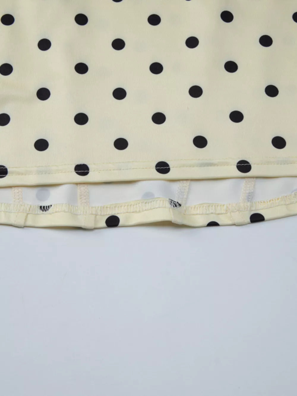 Pastel yellow polka dot tank top with sweetheart neckline detail