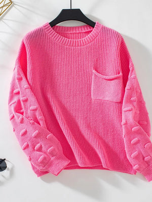 Hot pink knit sweater with textured sleeves and a chest pocket.