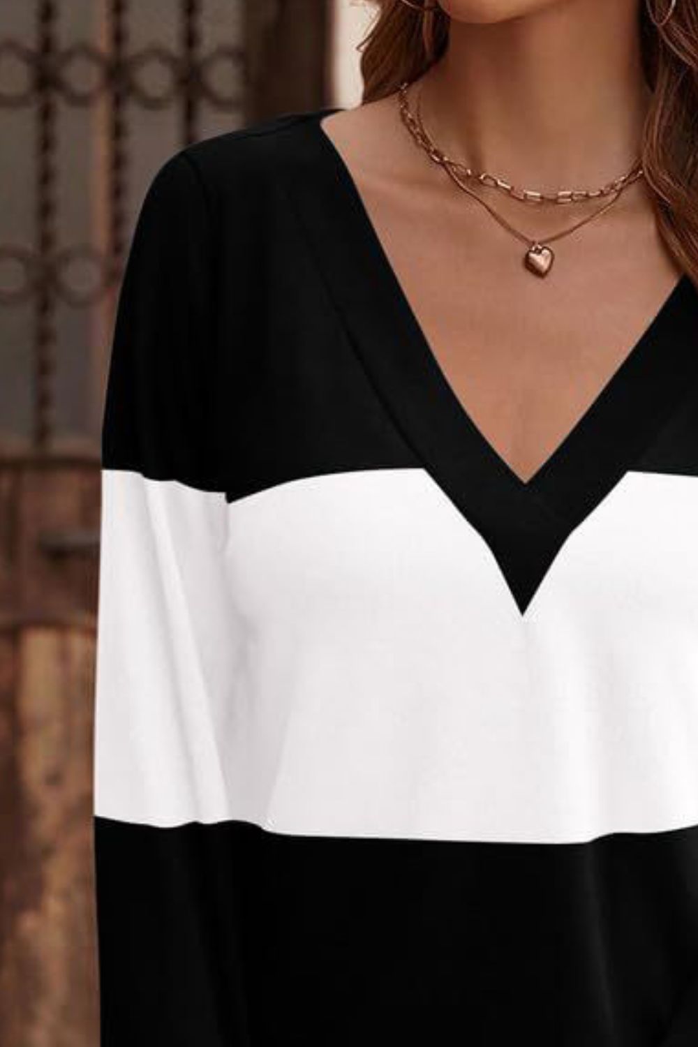 Black and white colorblock V-neck sweater with long sleeves.