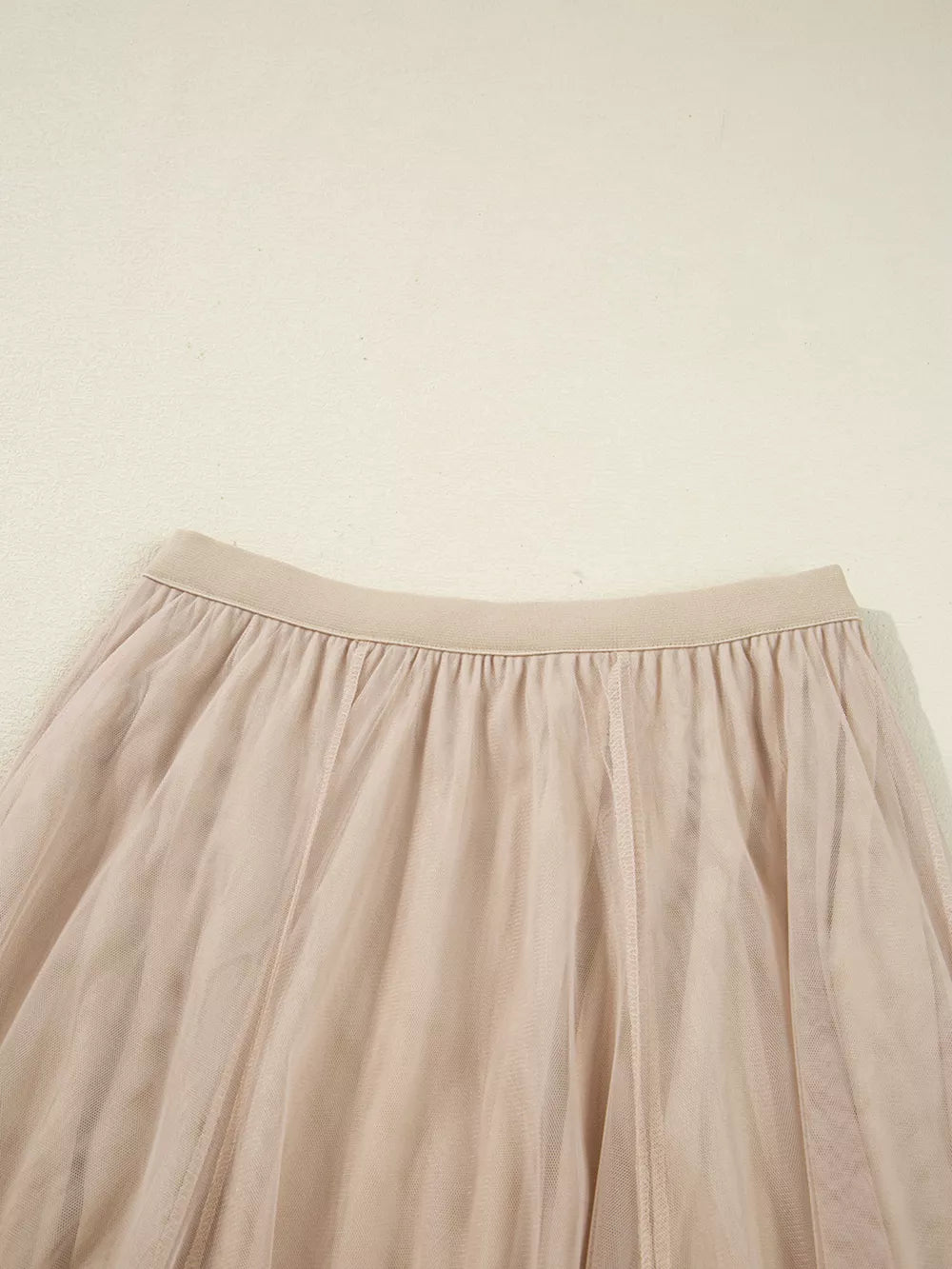 Lace overlay flared midi skirt in beige with elastic waistband and tulle fabric.