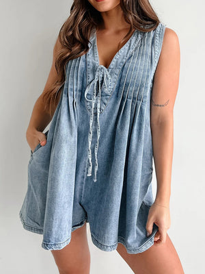 Light blue denim playsuit with tie-front neckline and pleated bodice.