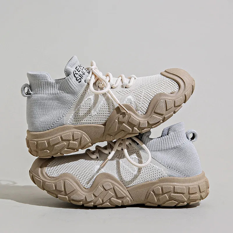 Sculpted knit athleisure sneakers in light grey with tan soles and white laces.