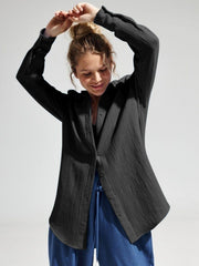 Black textured cotton overshirt with relaxed fit and button front.