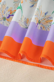 Sleeveless floral dress with purple and orange colorblock hem detail.