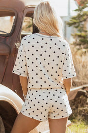 Women's polka dot pajama set with drawstring shorts and short sleeve top.