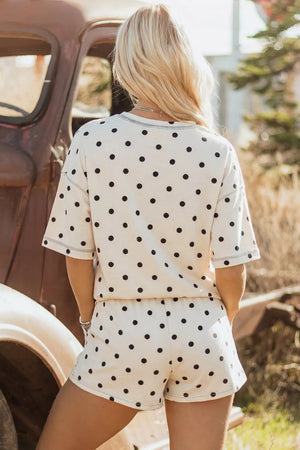Women's polka dot pajama set with drawstring shorts and short sleeve top.