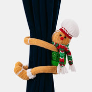 Gingerbread man curtain tieback with red and green scarf and white hat.