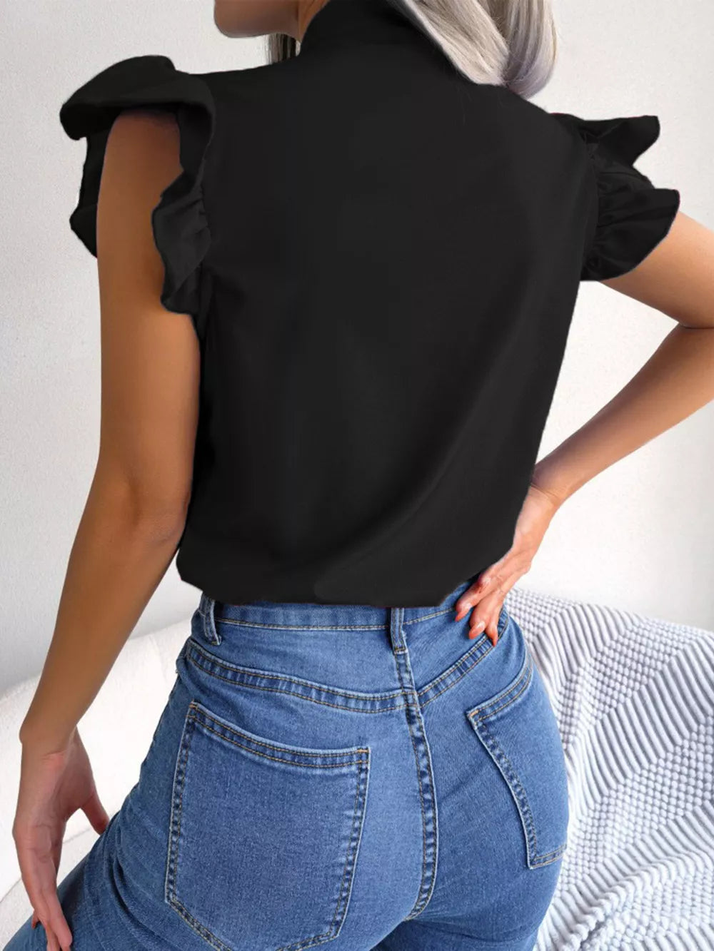 Black pussy-bow ruffle sleeve maternity blouse with a mock neck.
