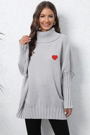 Light Gray batwing knit turtleneck sweater with red heart embroidery and ribbed sleeves.